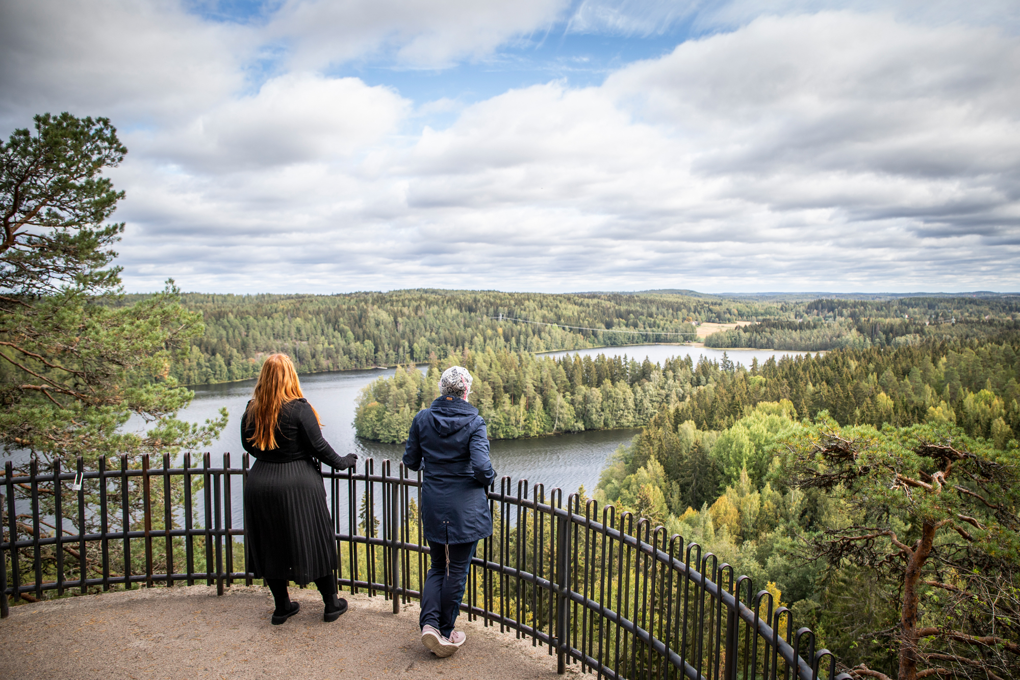 Two people admire the scenery from the Aulanko lookout.
