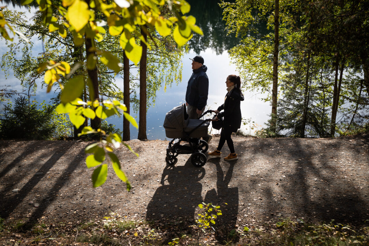 A couple out for a walk with a pram in Ahvenisto.