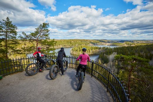Mountain bikers admiring the cultural landscape at the Aulanko observation tower viewing platform.