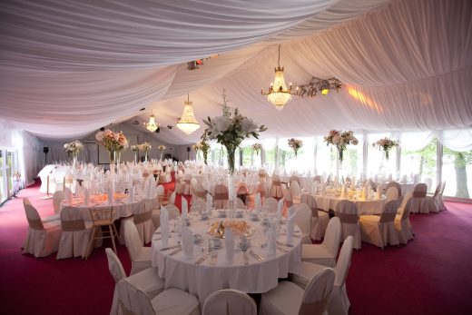 The Festive Pavilion set at Vanajanlinna. White tablecloths and round tables.