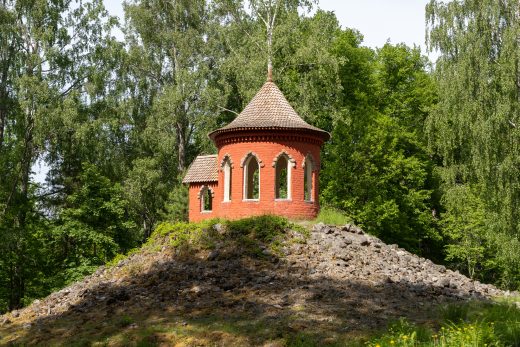 The brick building of the Temple of Fortune on a hill surrounded by trees.