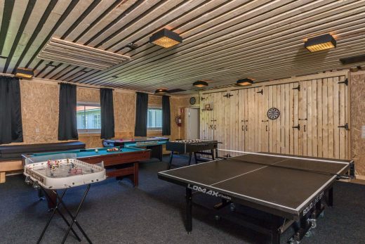 A lounge area with a ping-pong table and a billiard table.