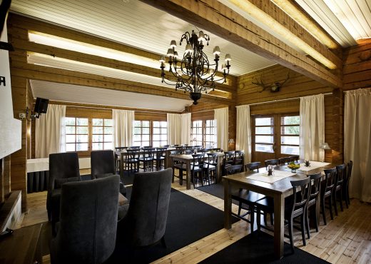 The restaurant space at Rantatalo set up for a meeting. The room is surrounded by large windows that let in plenty of light.