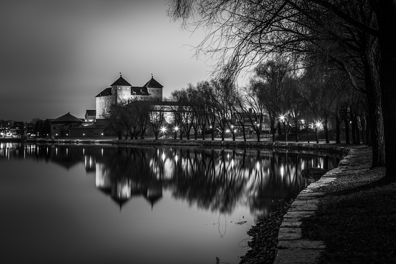 A black-and-white, moody image of Häme Castle.