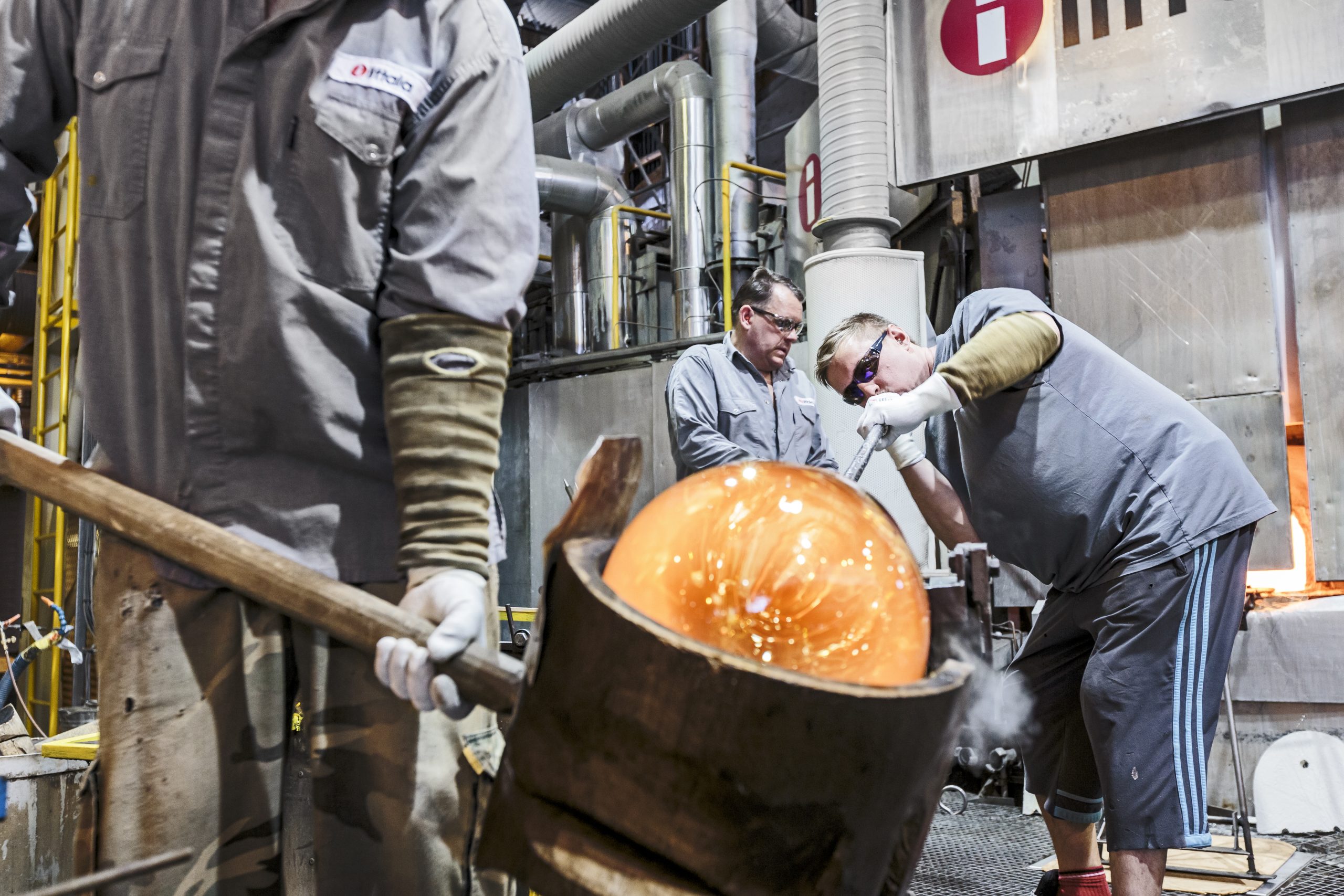 A man blowing glass at the Iittala glass factory