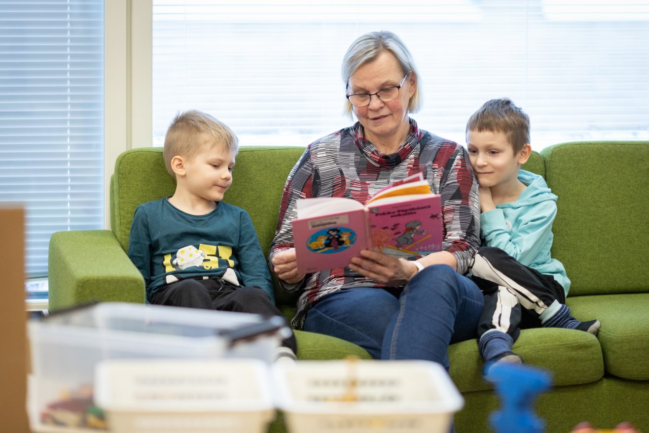 An adult reading to children.