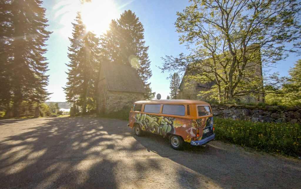 A colorful van parked in front of the church